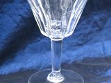 a clear wine glass sitting on a blue cloth