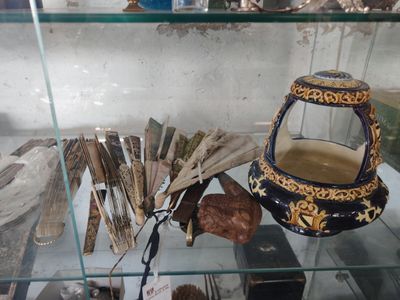a glass display case with a variety of items in it