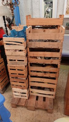 several wooden crates stacked on top of each other in a room