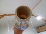 a person holding a glass vase with a picture on it