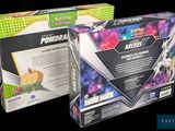 two boxes of pokemon trading cards are shown on a black background