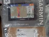 a garmin device sitting on top of a pile of other items