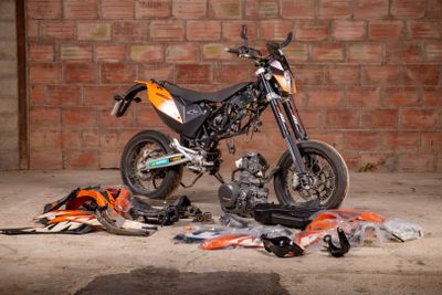 a motorcycle that is parked in front of a brick wall