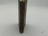 a small piece of wood with a yellow stick sticking out of it