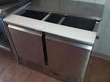 a stainless steel counter top with two sinks and a dishwasher