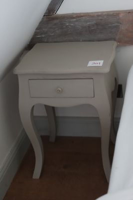 une petite table avec un tiroir dans le coin d'une pièce