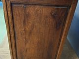 a wooden cabinet with a metal top on a wooden table
