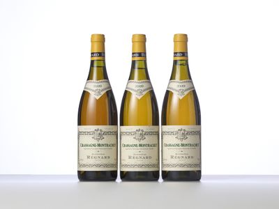 three bottles of wine sitting on top of a table next to each other