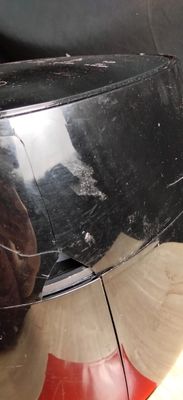 a cat that is sitting on the back of a car