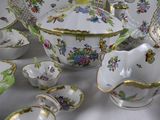 many different types of porcelain dishes and bowls on the table