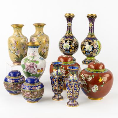 many different vases that are sitting on a white surface