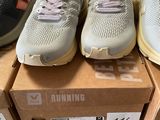several pairs of running shoes are on display in a store