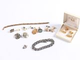 an assortment of jewelry including a bracelet, ring, bracelet, and bracelet box