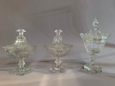 three clear glass vases sitting on top of a white table