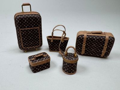 four pieces of louis vuitton luggage sitting next to each other
