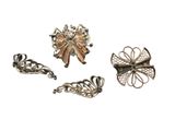 three silver and gold brooches with bows on them