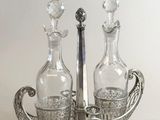 a silver tray with two bottles and a spoon on it