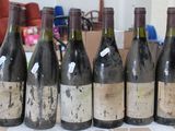 several bottles of wine are lined up on a table