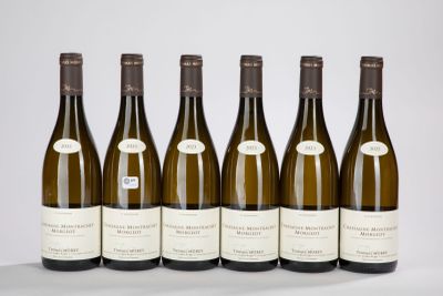 six bottles of wine lined up in a row on a table