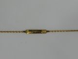 a gold bracelet with a clasp on a white background