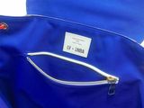 a blue bag that has a zipper on the inside of it