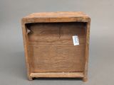 a small wooden box that has a tag on it
