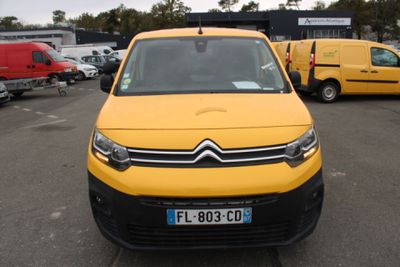 a yellow van that is parked in a parking lot