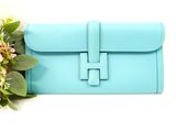 a blue purse with a flower on top of it