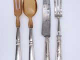 three forks, a spoon, and a knife on a table