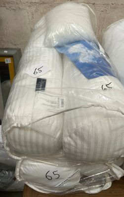 two pillows stacked on top of each other on a table