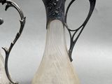 two vases that are next to each other on a table