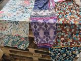 a pile of cloth on a pallet with a camera on it
