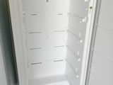 a white refrigerator with its door open in a kitchen