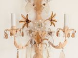 a wall sconce with a candle holder and two candles on it