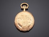 an antique gold pocket watch with a floral design on the dial