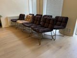 four chairs in a row in a room with a radiator