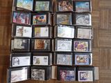 a lot of cd ' s sitting on a wooden floor