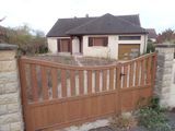 a wooden gate that is in front of a house