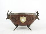 an image of a metal bowl with two deer heads on it