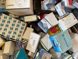 a cardboard box full of electronic devices and other items