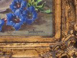 a painting of blue flowers in a gold frame