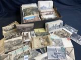 a lot of old postcards in a box on a table