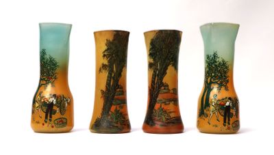 three vases that are sitting side by side on a white surface