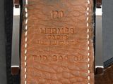 the watch is made of leather and has a brown strap