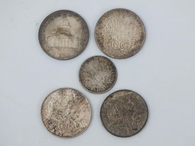 four different types of coins are shown on a white surface
