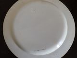a white plate on a table with a black background