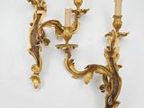 a pair of gilded wall sconces on a white background
