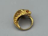 an image of a gold ring with a snake on it ' s side