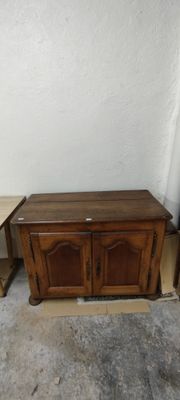 a small table and a small cabinet in a room