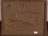a brown suitcase sitting on top of a wooden table